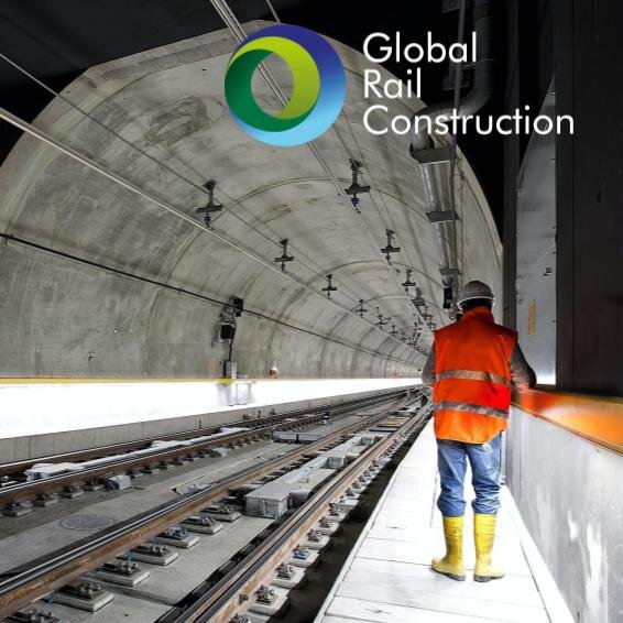 construction worker walking through a rail tunnel