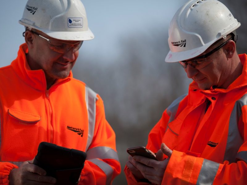 network rail workers with mobile phones